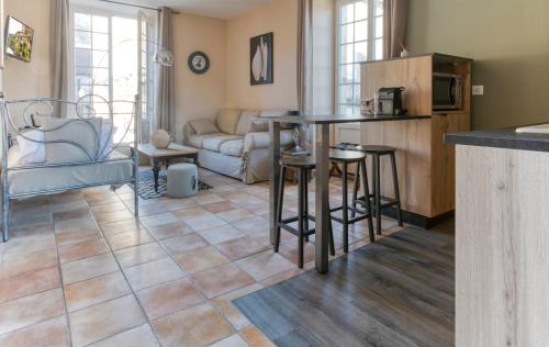 a living room with a table and a couch at Destination Périgord - Le Clos in Montignac