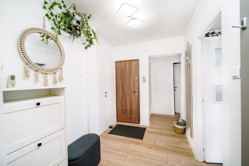 a living room with white walls and a wooden door at Family Stay - Calliope apartment - By OpenHouse in Timişoara