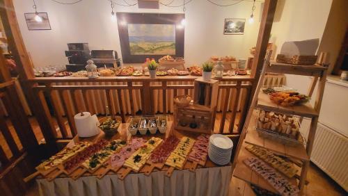 a buffet of food on display in a room at Penzion Zvonička in Pec pod Sněžkou