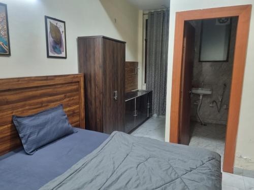 a bedroom with a bed and a bathroom with a sink at Hotel Galaxy Inn in Greater Noida