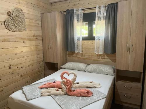 a bedroom with two towels on a bed at Jack und Benny Insel Bojana in Sveti Nikola