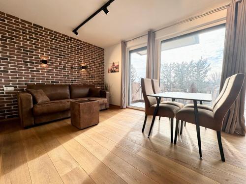 a living room with a couch and a table and chairs at Apartment mit Balkon in Vienna