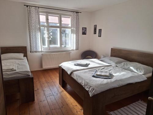 a bedroom with two beds and a window at Apartment 180 in Teplice nad Metují