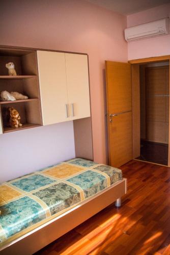a small bedroom with a bed and a cabinet at Hotel Holy in Međugorje