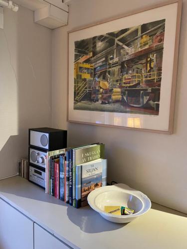 a table with books and a bowl on top of it at Villa Wargquist in Djuras