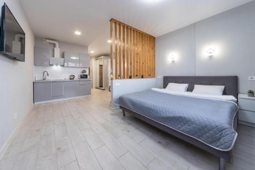 a bedroom with a large bed and a kitchen at Люкс на Бориспільській ЖК Олімпік Парк, генератор на будинку in Kyiv