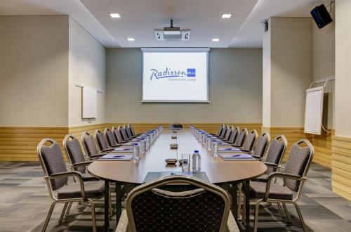 a conference room with a long table and chairs at Radisson Blu Resort & Spa Cesme in Cesme