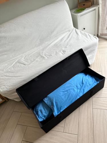 a bed with a box on the floor at Casa del sasso in Bergeggi