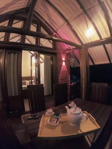 a table with a teapot on it in a room at Haven Harbour in Ella