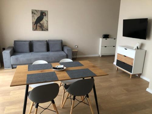 a living room with a table and chairs and a couch at Buena Vista Villas in Varna City