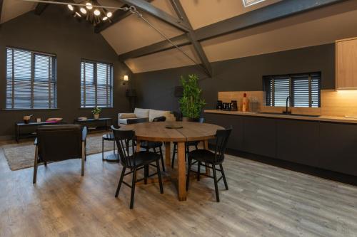 a kitchen and dining room with a table and chairs at Lord Street Lofts in Southport