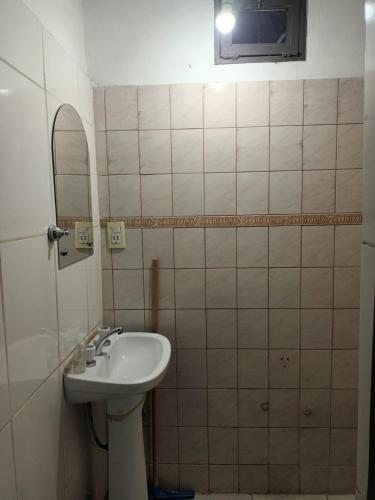 a small bathroom with a sink and a mirror at la pipi in Las Heras