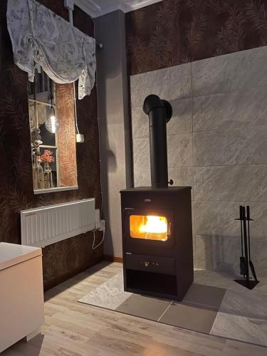 a fireplace in a living room with a stove at Liebevoll renoviertes Ferienhaus im schwedischen Lappland 