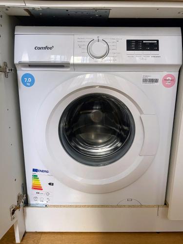 a white washing machine in a room at Loft Crocetta in Turin