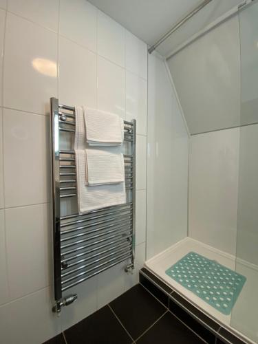 a bathroom with a towel rack with towels at Bellfosters in King's Lynn