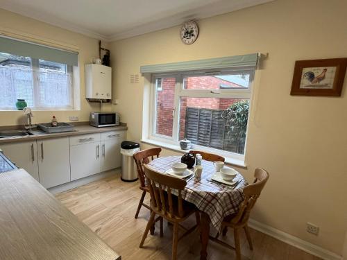 a kitchen and dining room with a table and chairs at Large Ground floor apartment in the heart of Church Stretton with free parking in Church Stretton