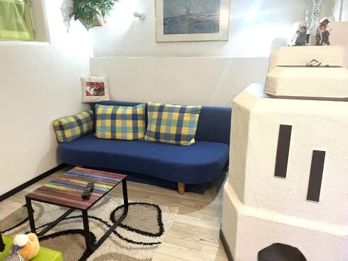 a living room with a blue couch and a table at Haus Rabensteiner in Scharnitz