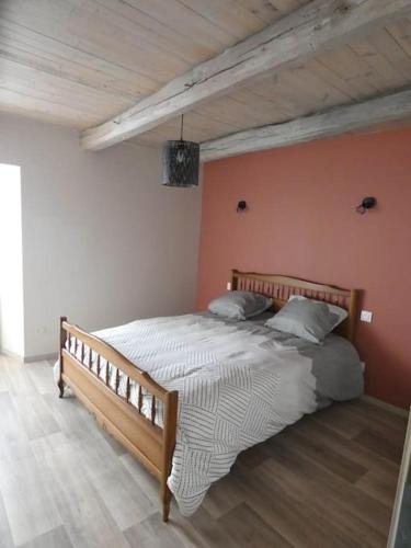 a bedroom with a large bed in a room at Maison entière située à proximité du centre thermal de Chaudes-Aigues in Espinasse