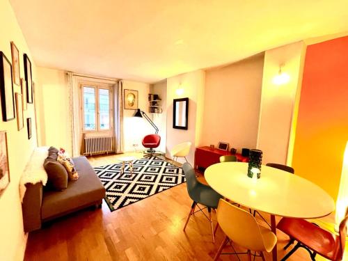 un salon avec une table et un canapé dans l'établissement Bel appartement Stade de France piscine olympique, à Saint-Denis