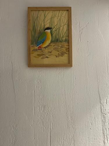 a painting of a bird hanging on a wall at Hôtel Candide in Saint-Bertrand-de-Comminges