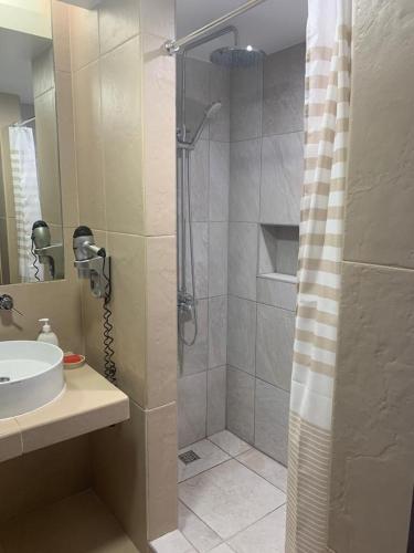 a bathroom with a shower and a sink at Salgados - Vila das lagoas, Beach & Golf in Albufeira