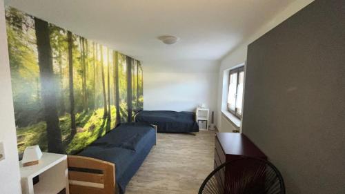 Habitación con 2 camas y una pintura en la pared. en Ferienappartement Grüner Elch, en Rheinhausen