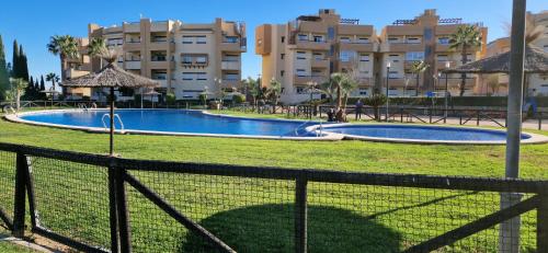 a swimming pool in front of a large building at Tranquila y bonita casa in Murcia