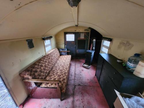 an empty room with a couch in a train car at Bushcraft survival nocleg dla samca alfa 