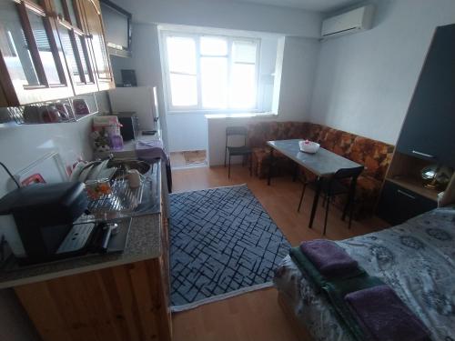 a living room with a table and a dining room at Apartment sunny morning in Sandanski