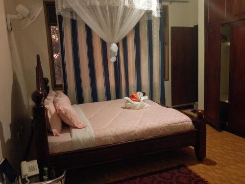 a bedroom with a bed with a canopy at DISCOVERY COURTS HOTEL in Entebbe