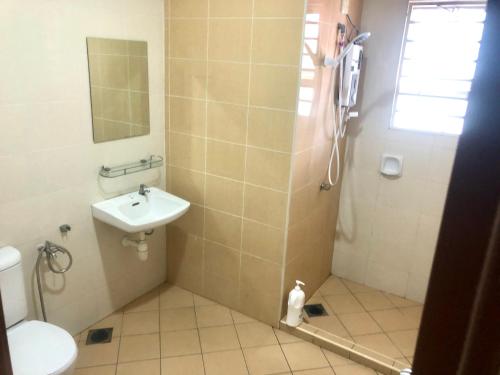 a bathroom with a toilet and a sink and a shower at SOFEA HOMESTAY Islam sahaja in Seremban
