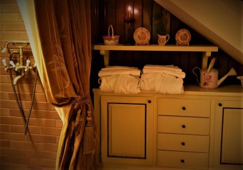a pile of towels on a shelf in a bathroom at Conacul Malul Alb in Râmnicu Vâlcea
