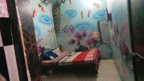a room with a bed with a fish mural on the wall at Hotel Prime (gajraj) in Sonīpat
