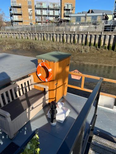 a boat with an orange life preserver on the deck at Judith Barge in Colchester
