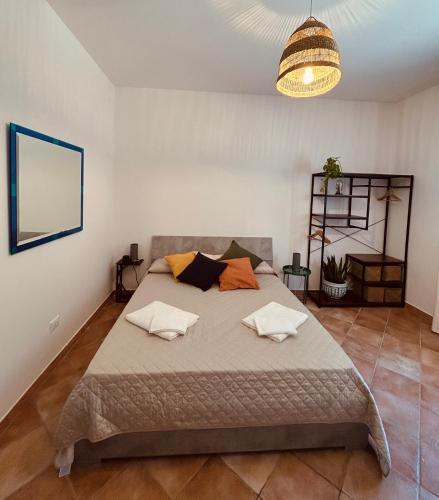 a bedroom with a large bed with two pillows at Villa Kalorama-private pool & Hot Tub in San Vito dei Normanni