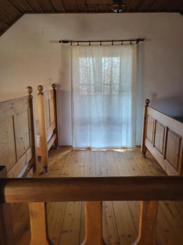 an empty room with a window and wooden floors at Apartmány Červený Dvůr in Chvalšiny