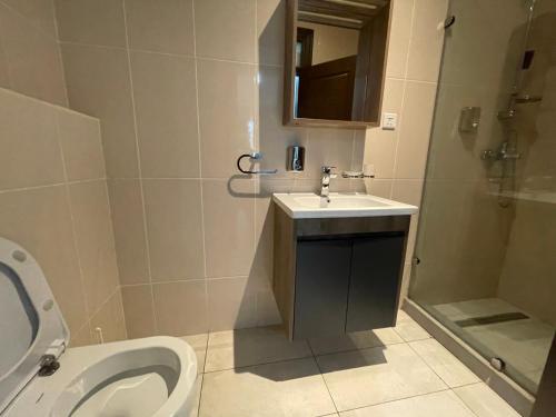 ein Bad mit einem WC, einem Waschbecken und einer Dusche in der Unterkunft Perfect Luxury @ Henrietta’s Residence in Accra