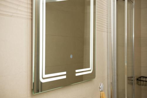 a mirror on the wall of a bathroom at Apartment Infinity in Kruševac