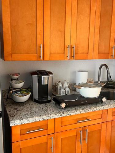 a kitchen counter top with a coffee maker and appliances at Casita Cafe in Miami