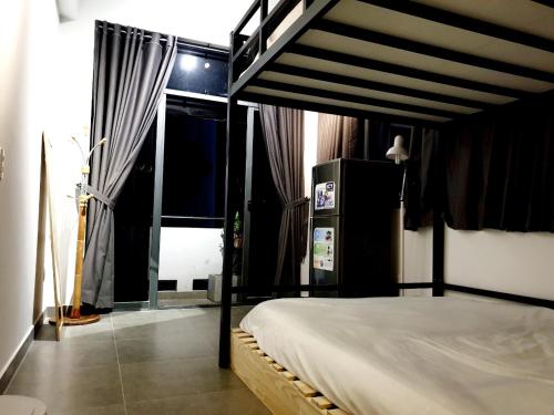 a bedroom with a canopy bed with a window at ZVillage NCC - Modern Townhouse in District 1 in Ho Chi Minh City