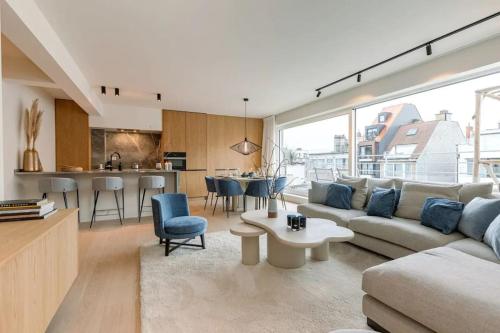 a living room with a couch and a table at Lush 3bed/3bath penthouse w deck in Knokke-Heist