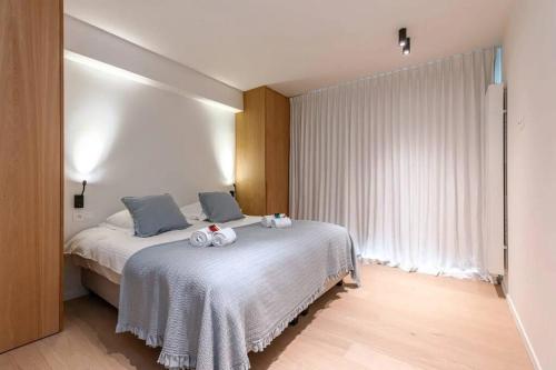 a bedroom with a bed with two stuffed animals on it at Lush 3bed/3bath penthouse w deck in Knokke-Heist