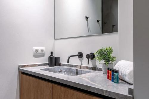 a bathroom with a sink and a mirror at Lush 3bed/3bath penthouse w deck in Knokke-Heist