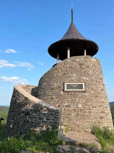 a brick tower with a sign on top of it at Kozmáry Vendégház in Matrafured