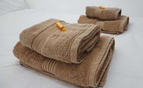 a stack of towels with a banana on top at Beautiful London home sleeps 6, 2 minutes to metro in London