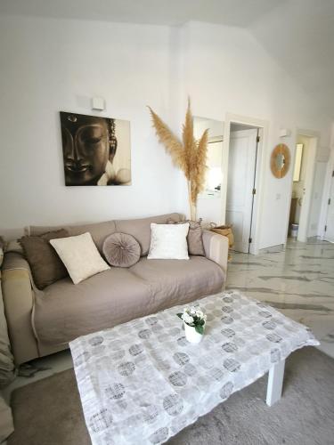 a living room with a couch and a table at wonderful penthouse with view playa las vistas in Arona
