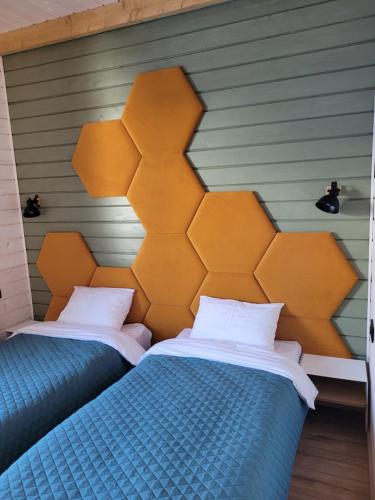 two beds sitting next to each other in a room at Шале Green Land in Bukovel