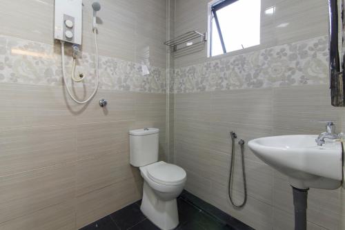 a bathroom with a toilet and a sink at Star Hotel in Port Dickson