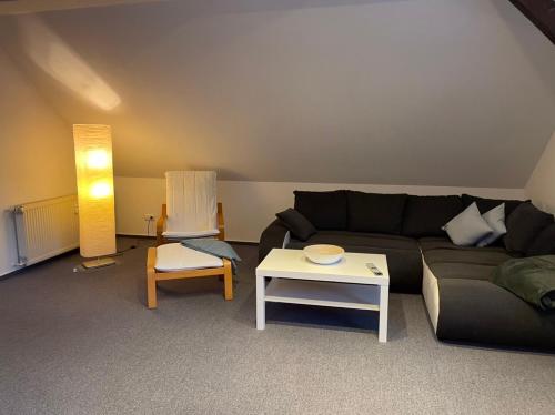 a living room with a couch and a table at Ferienwohnung Prälank direkt am See in Neustrelitz