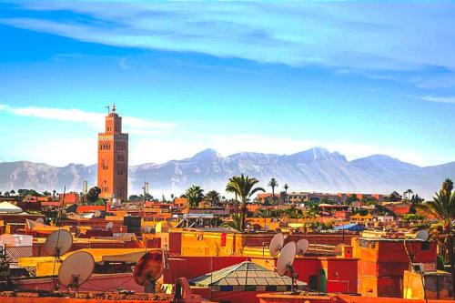a view of a city with a clock tower at Oasis appart sérénité in Marrakesh